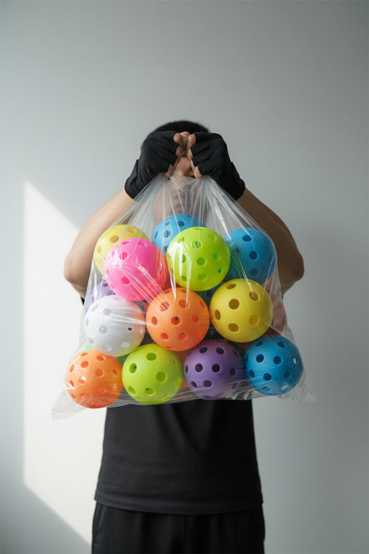 Colorful perforated balls on a light gray background