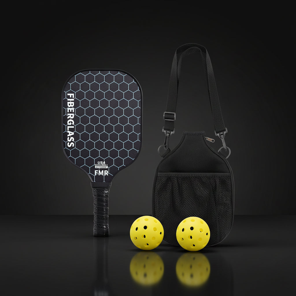 Pickleball paddle with hexagonal pattern, two yellow balls, and a black carrying bag on a white background.